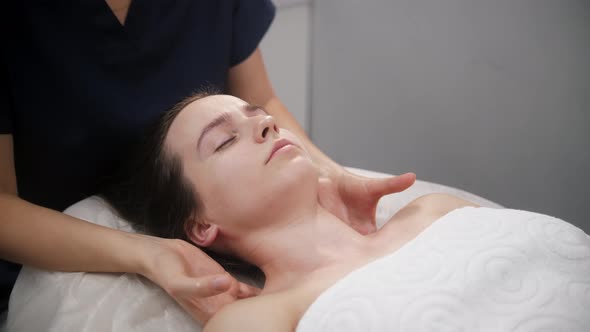 Massage Session  the Massagist Massaging Shoulders of Her Female Client alt