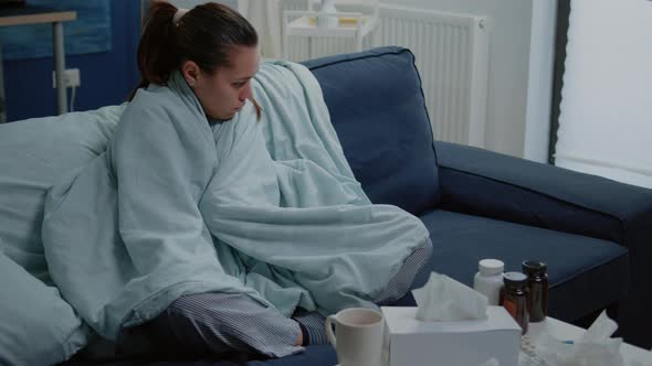 Sick Woman with Cold Using Blanket for Wamth at Home alt