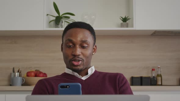 Happy Smiling African American Man Greeting His Friends on a Video Call on a Laptop at Home alt