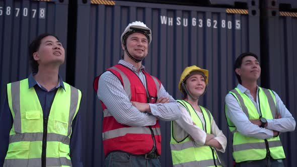 Cheerful dock worker team smiling with arms crossed in a shipyard
