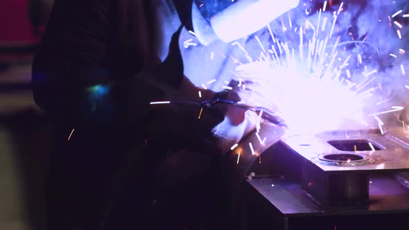 Welder Working with Metal in a Factory