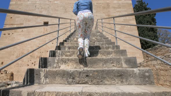Woman Tourist Is Walking Up on Stair of Kolossi Castle, Medieval Fortress on Cyprus