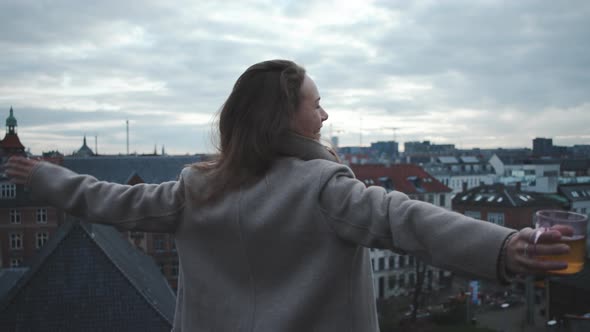 Woman With Arms Out To City alt