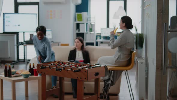 Man Playing Soccer Game with Woman at Foosball Table alt