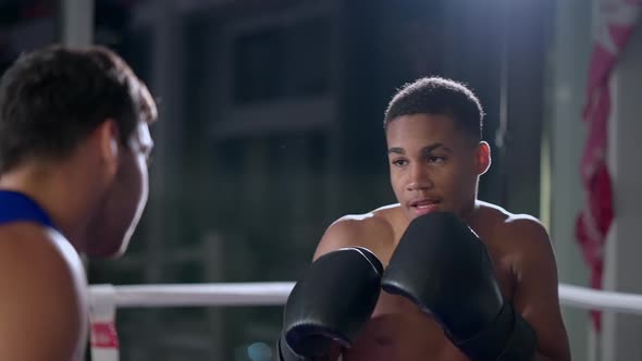 Boxing Trainer Working with Young Latino Sportsman alt