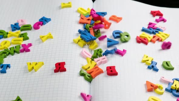 falling multicolored wooden letters of the English alphabet alt