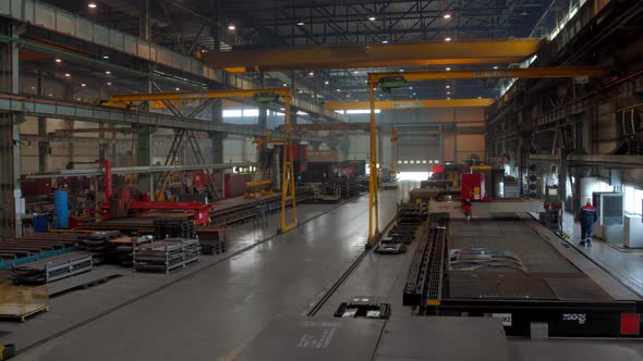 A Huge Workshop of a Metallurgical Plant with Workers and Equipment