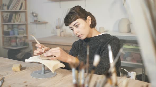 Woman working in the pottery workshop.