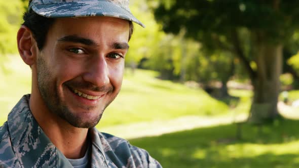Portrait of smiling soldier in park alt