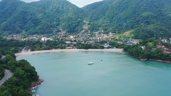 Aerial: drone shot in brazil santa rita beach ubatuba with view to yacht park sailboats in on the ro alt