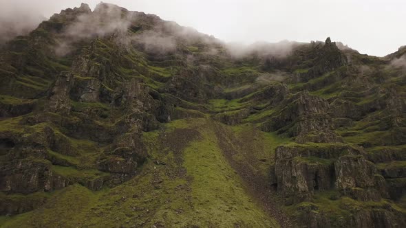 An aerial of a lush mountain on a moody day in iceland alt