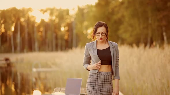 Successful Business Woman in Suit and Glasses Walks at You During Quarantine Outdoors alt
