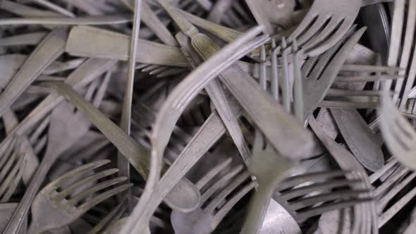 Pile of aged, tarnished forks, mixed design old collectible flatware alt