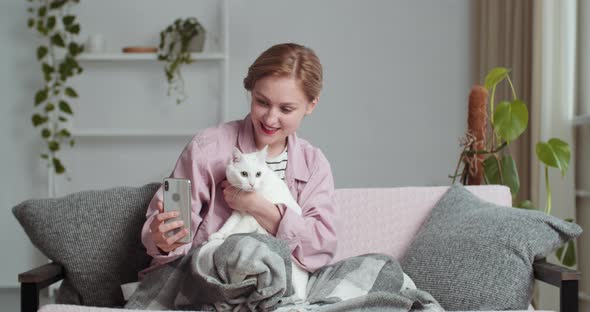 Beautiful Young Smiling Woman Blonde Girl Makes Selfie Photo with Beloved White Cat Adorable Pet for alt