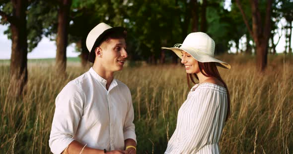 Portrait of Couple in Hats Countryside