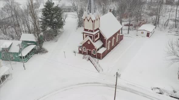 Beautiful church amidst snowfall Aerial 4K alt