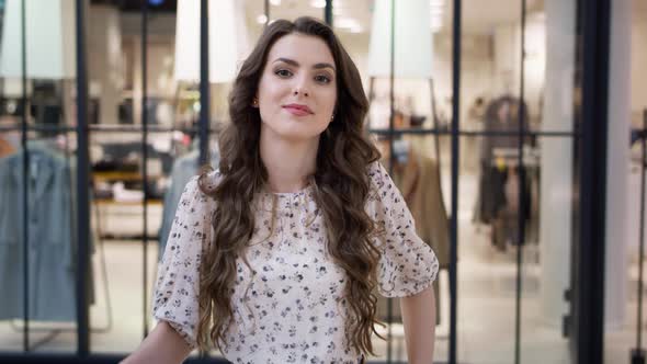 Video portrait of beautiful woman with shopping bags in mall. Shot with RED helium camera in 8K.  alt