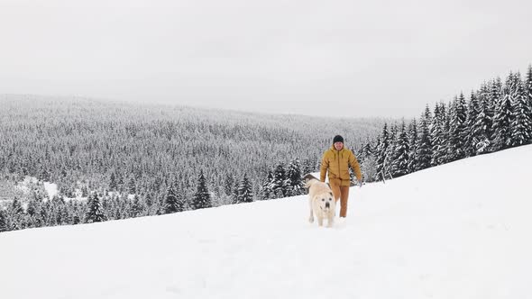 Man Walking With His Happy Dog In Snow