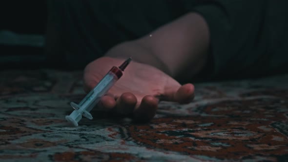 Overdose Addict's Hand Falls to the Floor Drug Syringe Falls Out of It alt