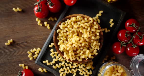Pasta Dry Cavatappi on Cutting Board Rotates Slowly.  alt