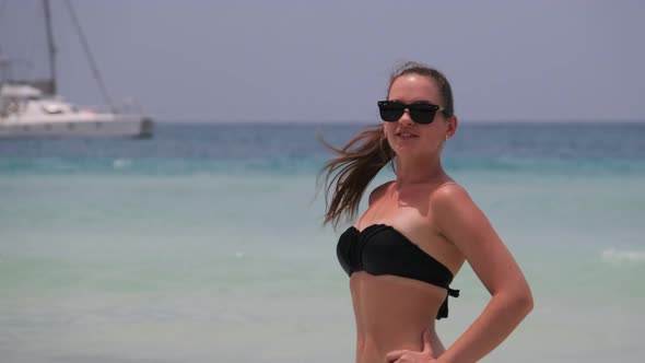 Young Woman in a Bikini Posing on Exotic Beach at the Turquoise Ocean Zanzibar alt