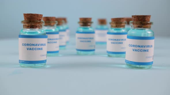 Syringe Needle a Drop Liquid Blurred Pfizer Company on the Blue Background alt