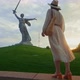 A young girl looking at Mother Motherland on the Mamayev Kurgan at sunset - VideoHive Item for Sale