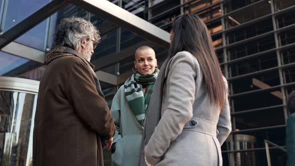 Team of Business People Enjoying Conversation Outside the Workplace in Winter alt