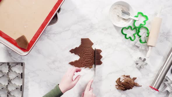 Flat lay. Step by step. Cutting out shapes with Christmas cookies cutter from gingerbread cookie dou alt
