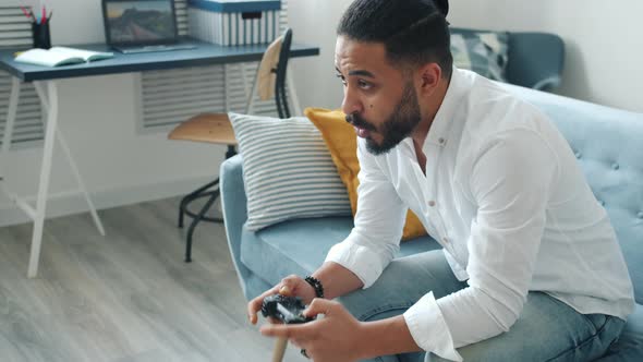 Emotional Afro-American Man Playing Video Game Screaming Having Fun at Home alt