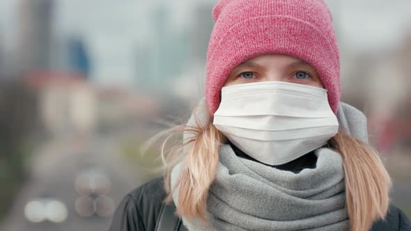 Woman in Surgical Face Mask. COVID-19 Coronavirus Pandemic or Smog Background.