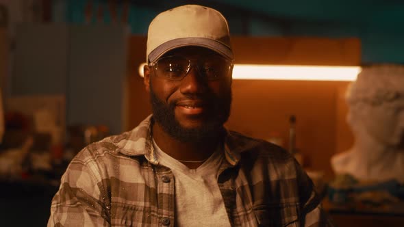 Friendly Black Artisan in Workshop alt