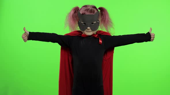 Funny Child Girl in Costume and Mask Plays Super Hero. National Superhero Day alt