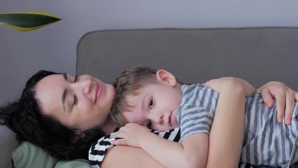 Happy Family Concept. Cute Affectionate Son Hugs Mother of Parents with Closed Eyes, Adorable Child alt