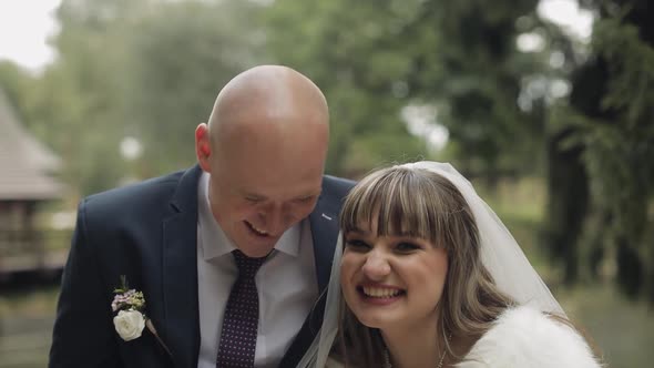Caucasian Groom with Bride in the Park. Wedding Couple. Happy Family. Newlyweds alt