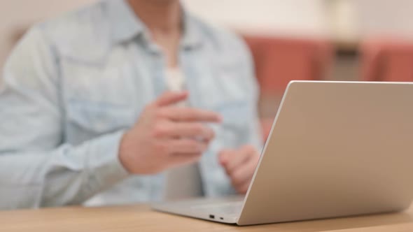 Man Showing Hand Shake Sign While Using Laptop Close Up alt