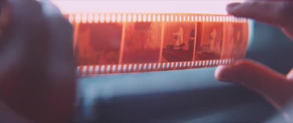 Close up of a film strip, showing a portrait of a man alt