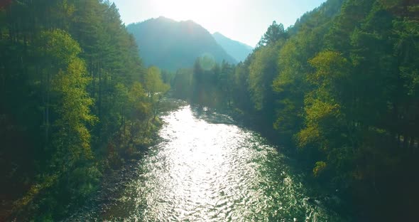 Low Altitude Flight Over Fresh Fast Mountain River with Rocks at Sunny Summer Morning. alt