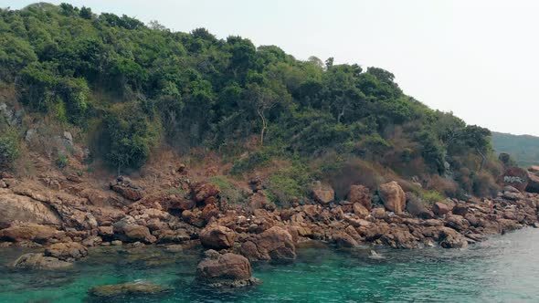 Flycam Moves To Island Forest Stones and Ocean Blue Water alt