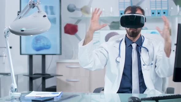 Doctor Wearing a VR Headset Working in Virtual Space in His Moder Office alt