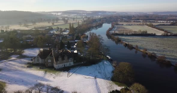 Aerial footage over river thames on a snowy, wintery morning alt