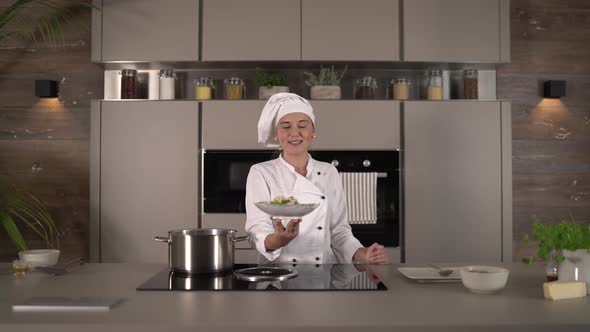 Talking Female Chef Cook Presenting Fresh Meal in Kitchen