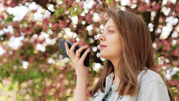 Girl Using Smart Phone Voice Recognition Dictates Thoughts Voice Dialing Message Outdoor