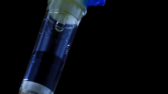 Medical Dropper Close Up in the Light of a Special Signal of a Police Car alt