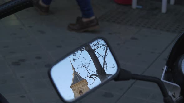Tower seen in a motorcycle mirror alt