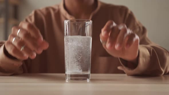 Close Up Sparkling Water Glass with Dissolving Effervescent Aspirin Pill alt