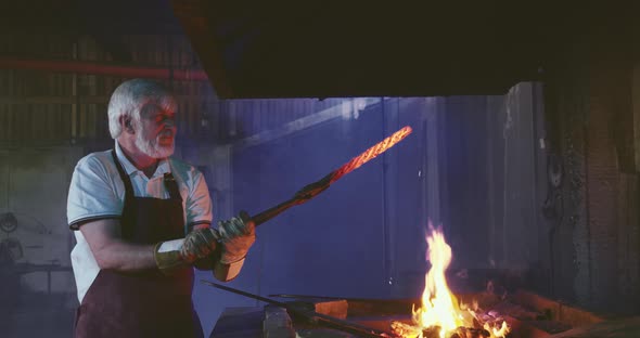 Old Man Forging in Smithy