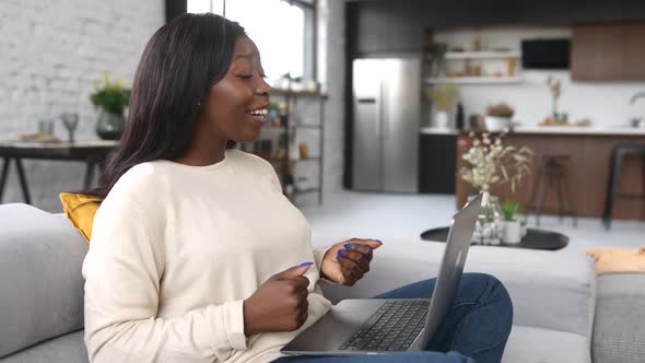 Multiracial Young Woman is Using Laptop for Video Call
