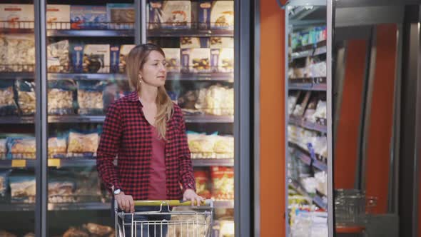 Adult Woman Choosing Fresh Products in the Hypermarket