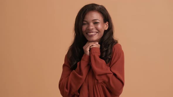 A happy brunette african american woman rejoicing alt